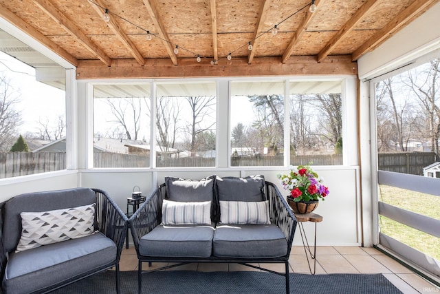 sunroom featuring beamed ceiling