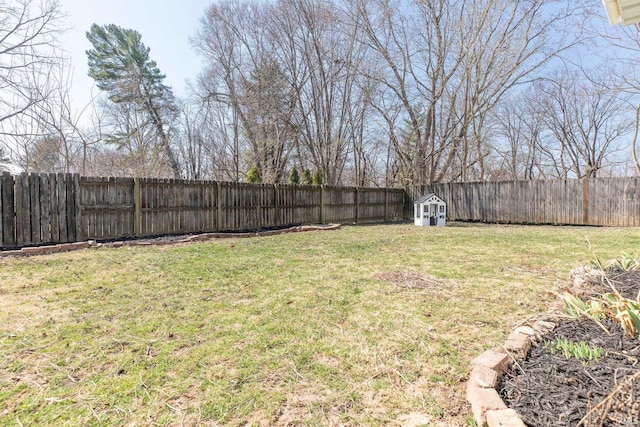 view of yard featuring an outdoor structure and a fenced backyard