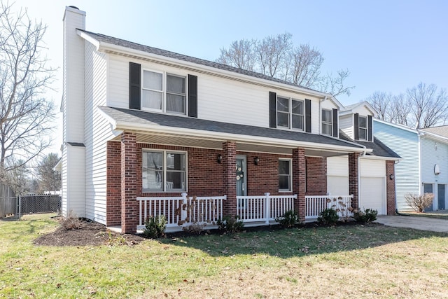 traditional-style home featuring a front yard, a porch, a chimney, a garage, and brick siding