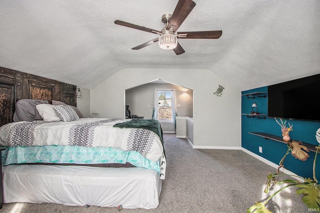 carpeted bedroom featuring baseboards, lofted ceiling, a textured ceiling, and a ceiling fan