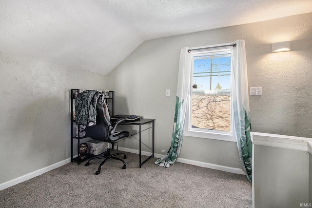 carpeted home office featuring baseboards, a textured ceiling, a textured wall, and vaulted ceiling