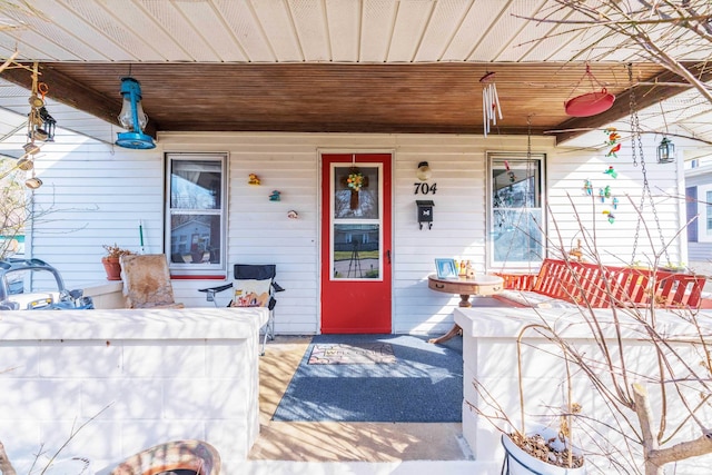 doorway to property featuring covered porch