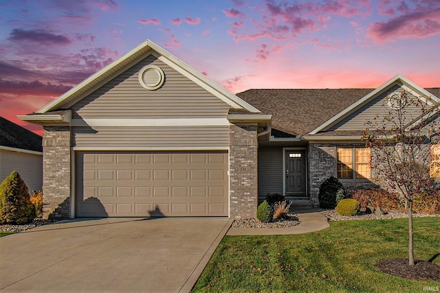 ranch-style house featuring a garage, brick siding, concrete driveway, and a front lawn