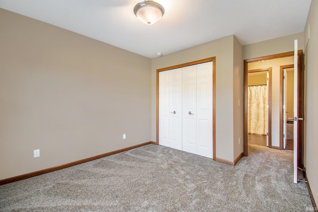 unfurnished bedroom featuring a closet, carpet flooring, and baseboards