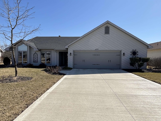 ranch-style house with a garage, concrete driveway, a front yard, and a shingled roof