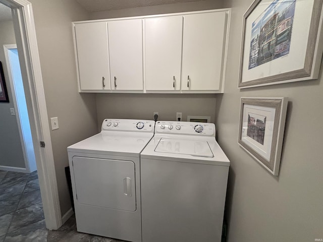 laundry room with cabinet space, independent washer and dryer, and baseboards