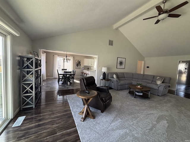 living area with beam ceiling, ceiling fan with notable chandelier, visible vents, and dark wood-style flooring