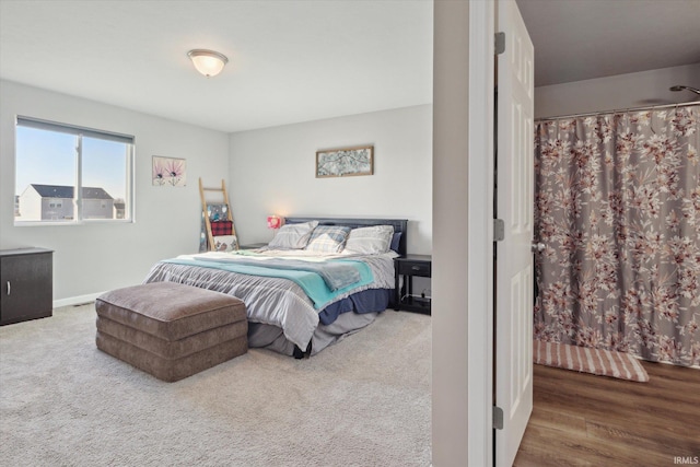 bedroom featuring baseboards and carpet