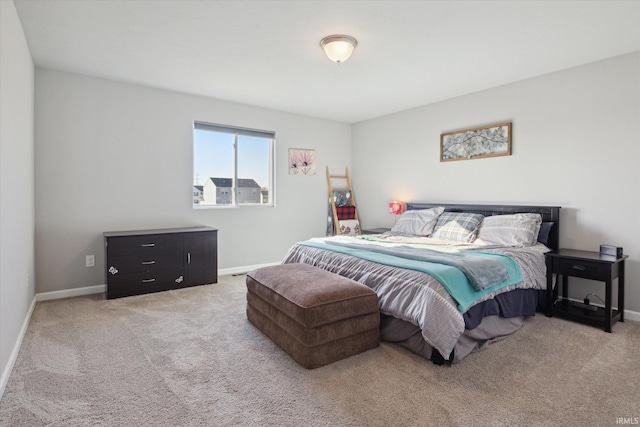 carpeted bedroom featuring baseboards