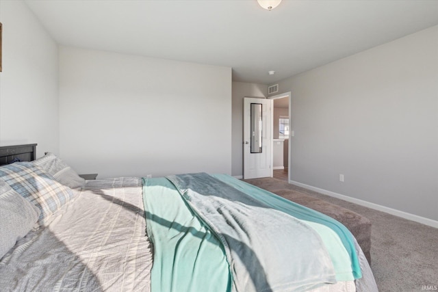 carpeted bedroom featuring baseboards and visible vents