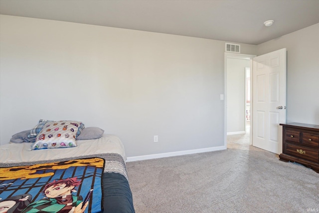 carpeted bedroom featuring visible vents and baseboards