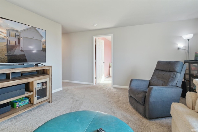 sitting room featuring carpet flooring and baseboards