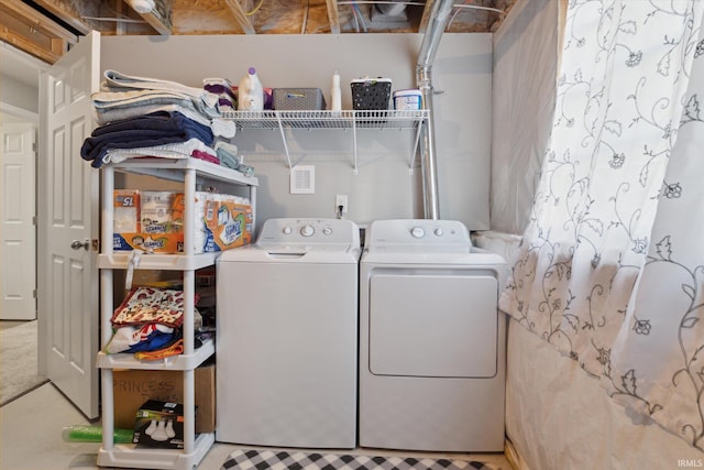 washroom with independent washer and dryer and laundry area