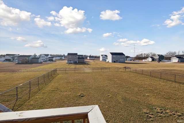 view of yard with a rural view, a residential view, and fence