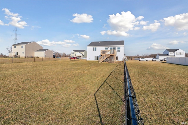 view of yard with stairway and a fenced backyard