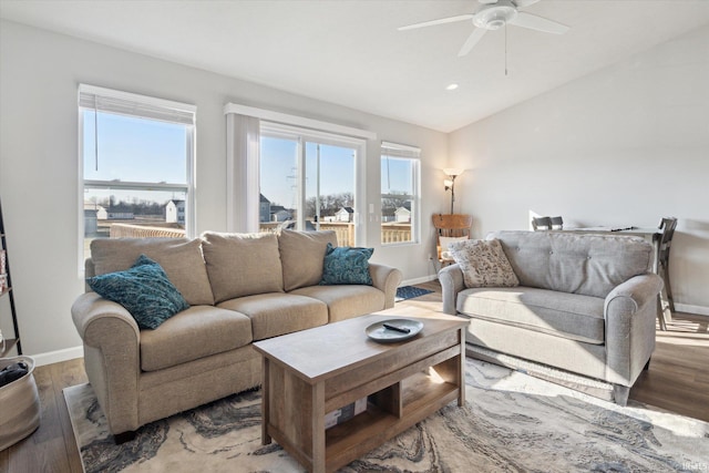 living area featuring plenty of natural light, ceiling fan, lofted ceiling, and wood finished floors