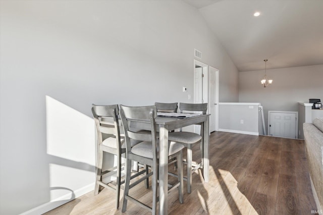 dining room with an inviting chandelier, wood finished floors, visible vents, and baseboards