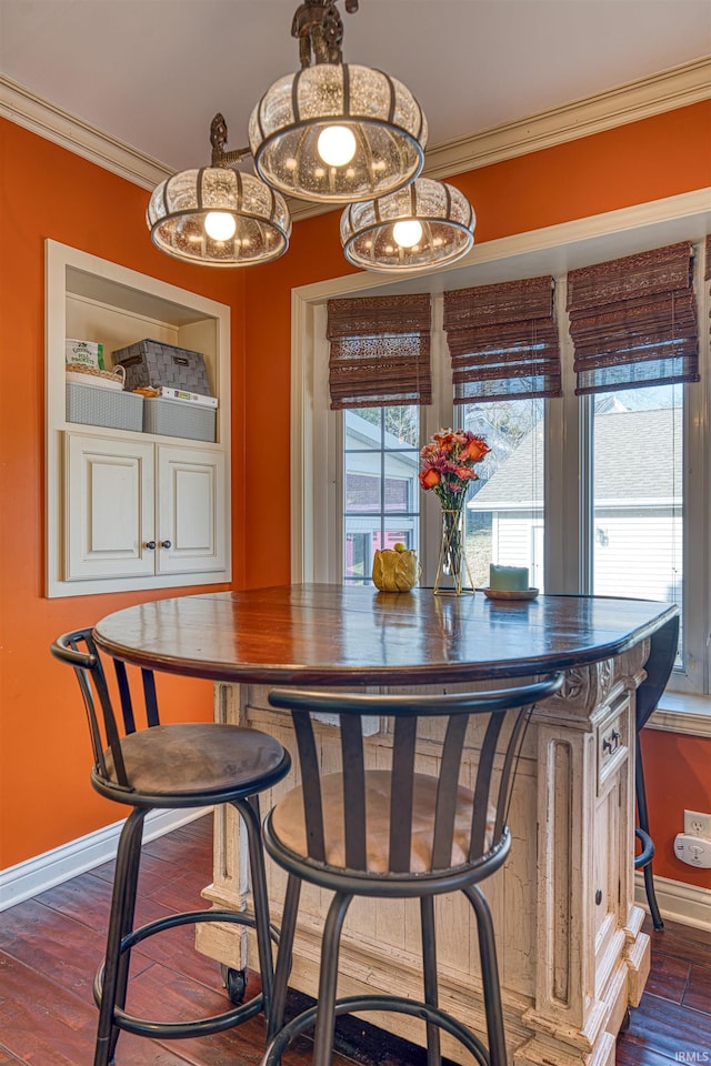 dining room featuring crown molding, dark wood-style floors, and baseboards