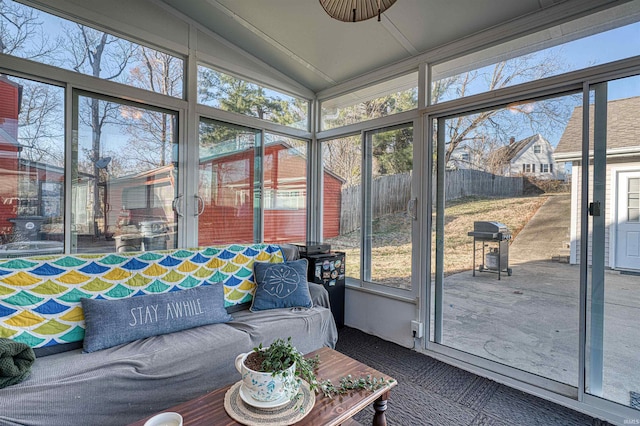 sunroom / solarium featuring vaulted ceiling