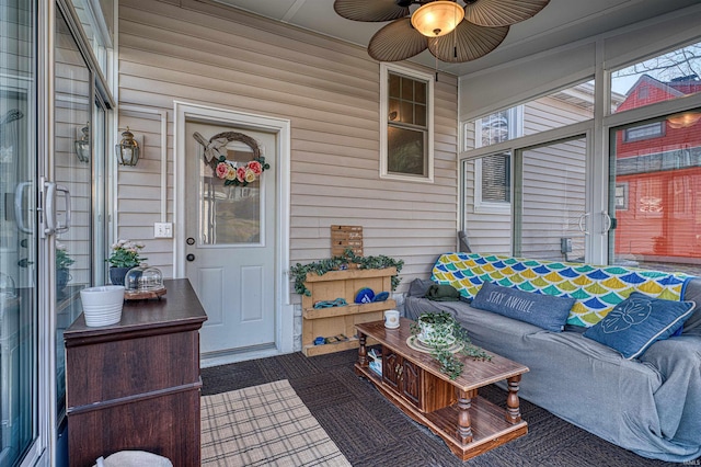 sunroom featuring a ceiling fan