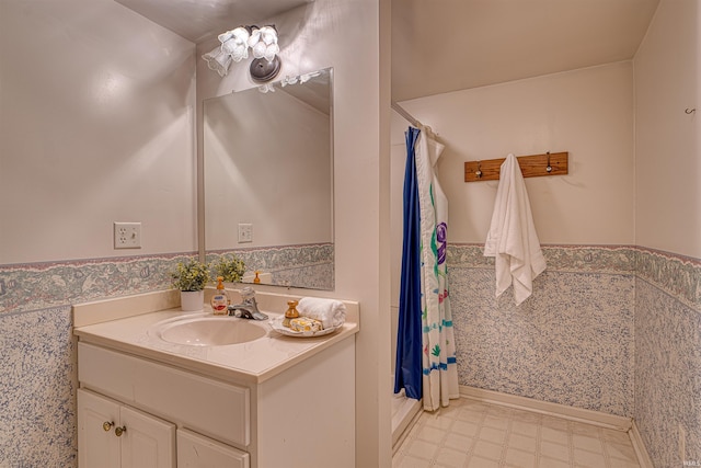 full bathroom featuring tile patterned floors, wainscoting, vanity, and a shower with curtain