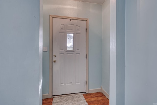 entrance foyer with baseboards and wood finished floors