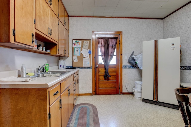 12228 Indiana St, Leopold, IN 47551 - kitchen with a sink, light floors, crown molding, and wallpapered walls