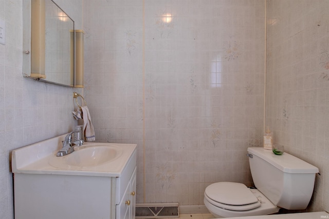 12228 Indiana St, Leopold, IN 47551 - bathroom with vanity, tile walls, toilet, and visible vents