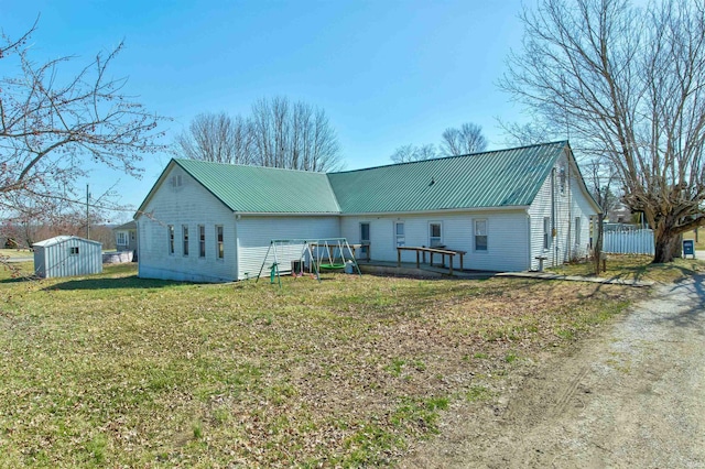 12228 Indiana St, Leopold, IN 47551 - rear view of property featuring an outbuilding, a storage unit, a yard, and metal roof