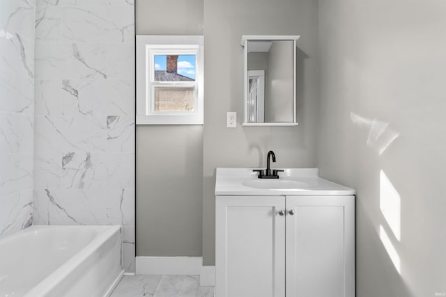 bathroom featuring vanity, baseboards, and marble finish floor