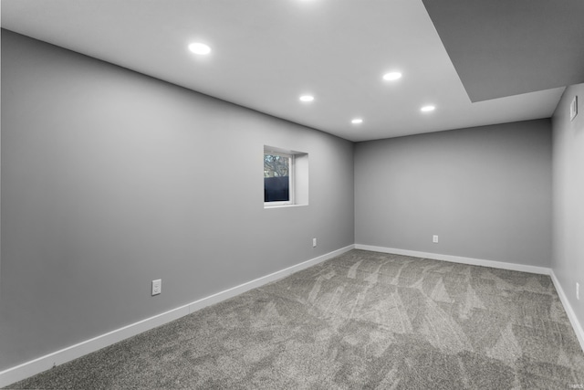 empty room featuring carpet flooring, recessed lighting, and baseboards