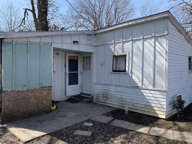 entrance to property featuring board and batten siding