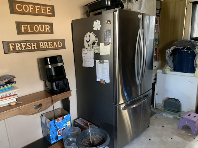 kitchen with tile patterned floors and freestanding refrigerator