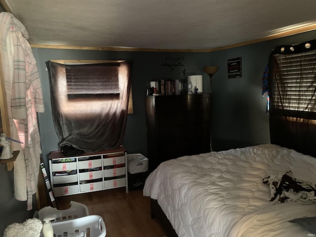 bedroom with wood finished floors