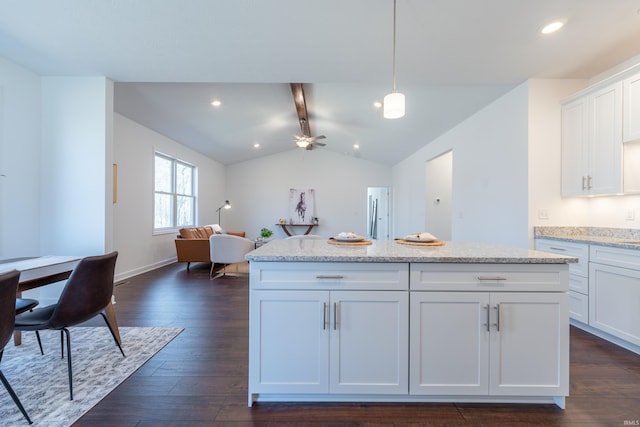 kitchen with vaulted ceiling with beams, a kitchen island, dark wood finished floors, open floor plan, and white cabinets