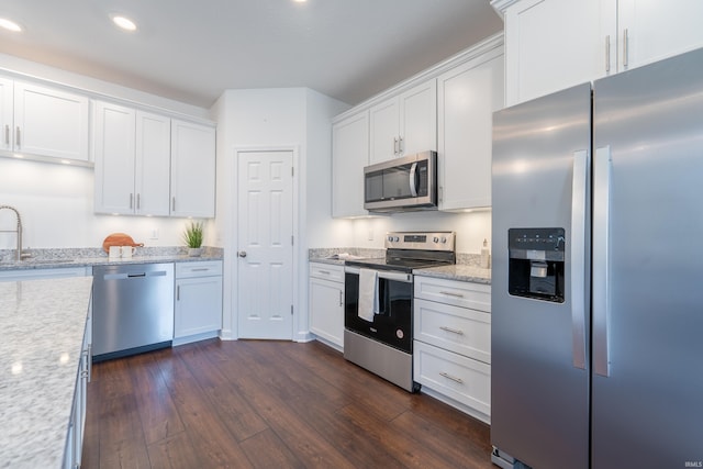 kitchen featuring dark wood finished floors, recessed lighting, white cabinets, stainless steel appliances, and a sink