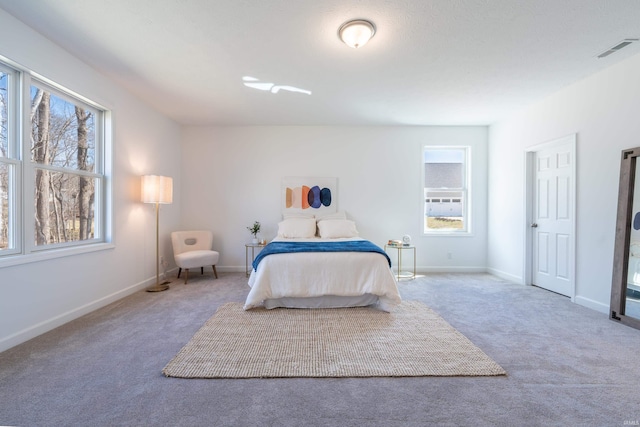 bedroom with carpet flooring, baseboards, and visible vents