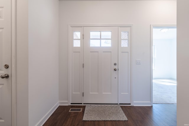 entrance foyer featuring visible vents, baseboards, and dark wood-type flooring