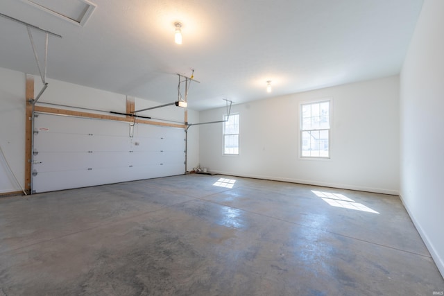 garage with a garage door opener and baseboards