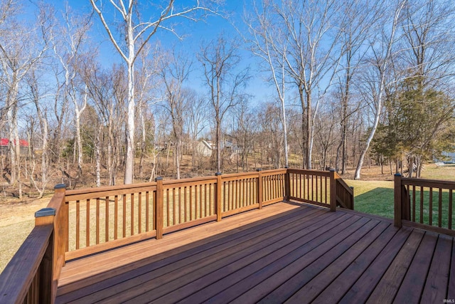 wooden terrace featuring a yard