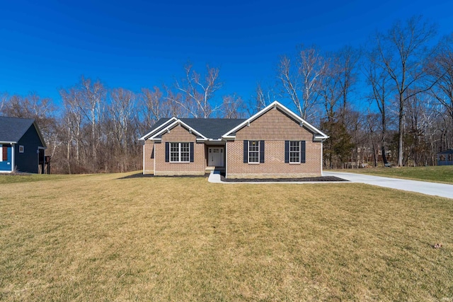 single story home with a front yard, concrete driveway, and brick siding