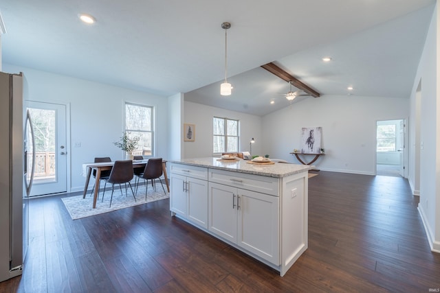 kitchen with dark wood-style floors, stainless steel refrigerator, vaulted ceiling with beams, and white cabinetry