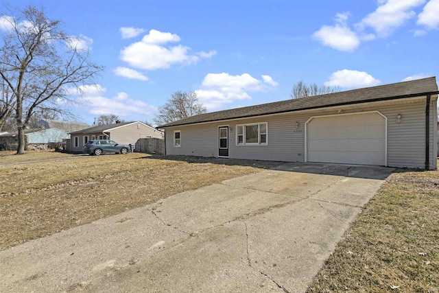 ranch-style home with concrete driveway and a garage