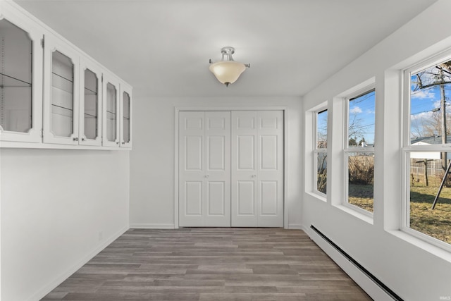 unfurnished sunroom featuring baseboard heating