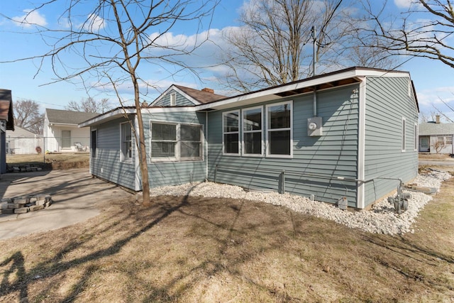 view of front of property with a patio and fence