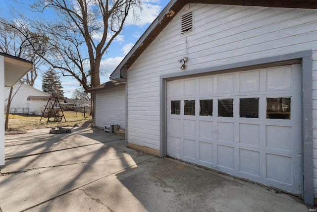 garage with concrete driveway