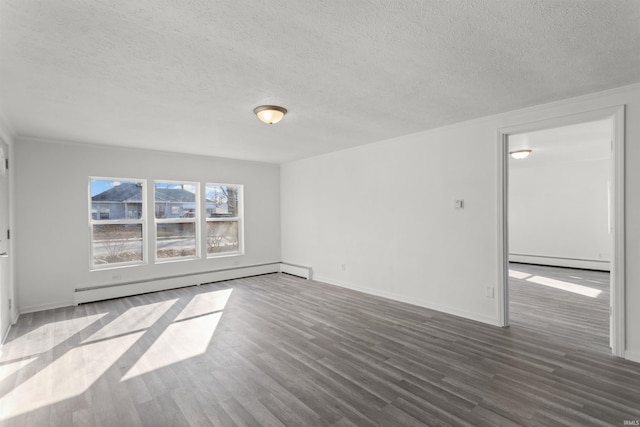 spare room featuring baseboards, baseboard heating, wood finished floors, a textured ceiling, and a baseboard radiator