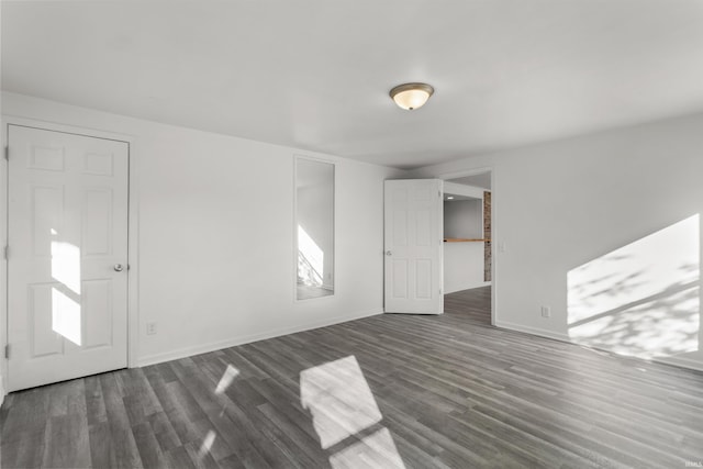 interior space with dark wood-style floors and baseboards