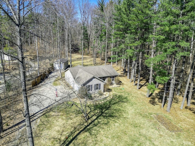 drone / aerial view featuring a wooded view