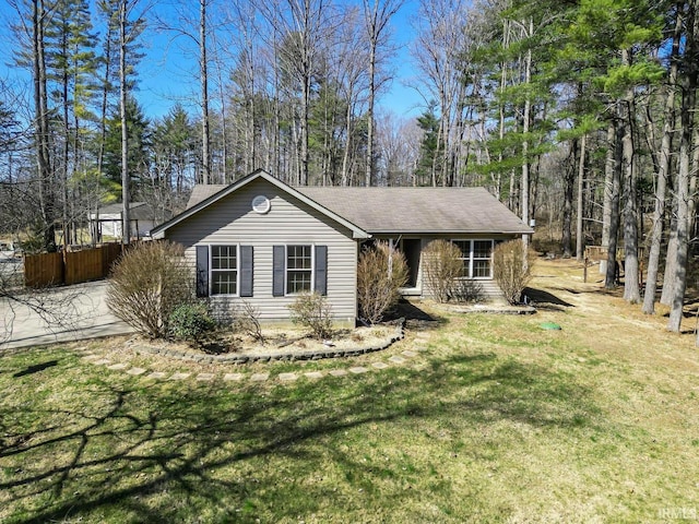 single story home featuring a front yard and fence